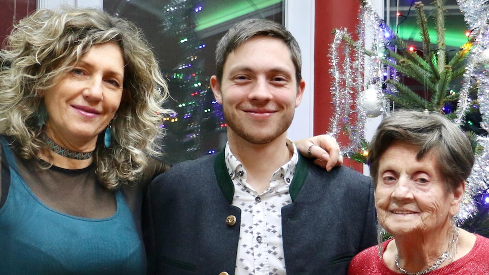 Un homme accompagné de deux femmes célébrant Noël.
