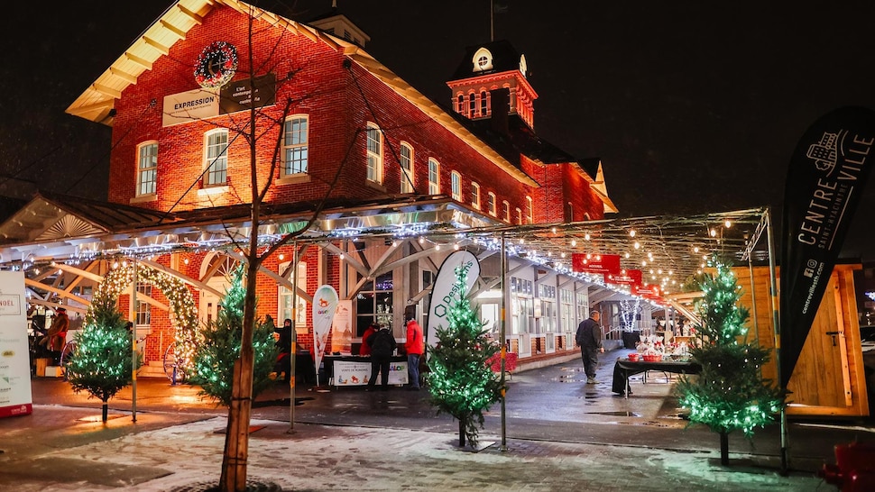 Le Marché de Noël de Saint-Hyacinthe illuminé la nuit avec une couche de neige.