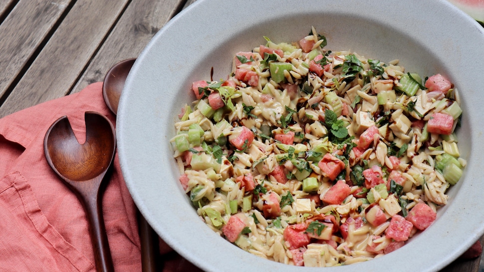 Dans un bol, il y a de la salade d'orzo au melon et au tofu.