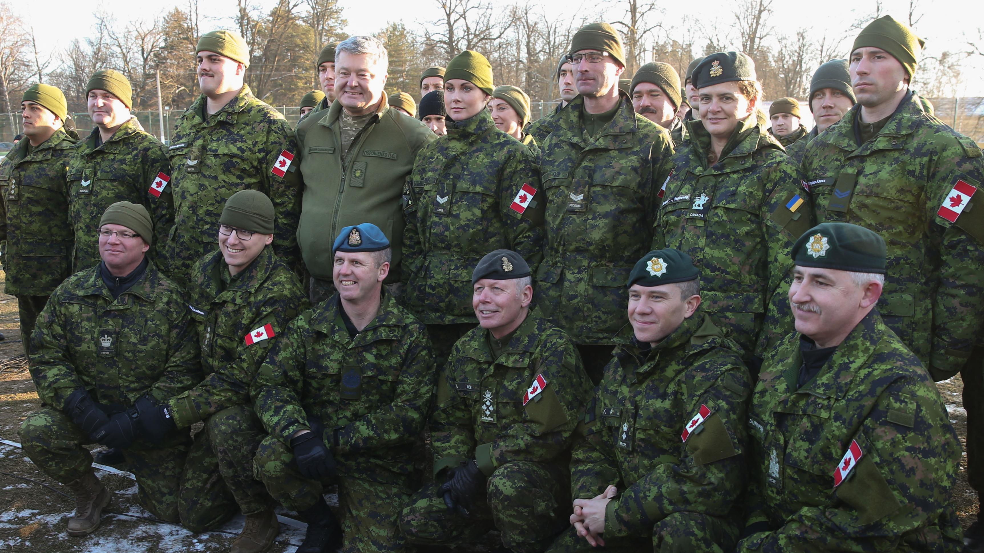 Canadian Gov. Gen. Julie Payette (second right, top row) and Ukrainian President Petro Poroshenko pose for a photo with Canadian soldiers at the International Peacekeeping and Security Centre, on Thursday, Jan. 18, 2018.