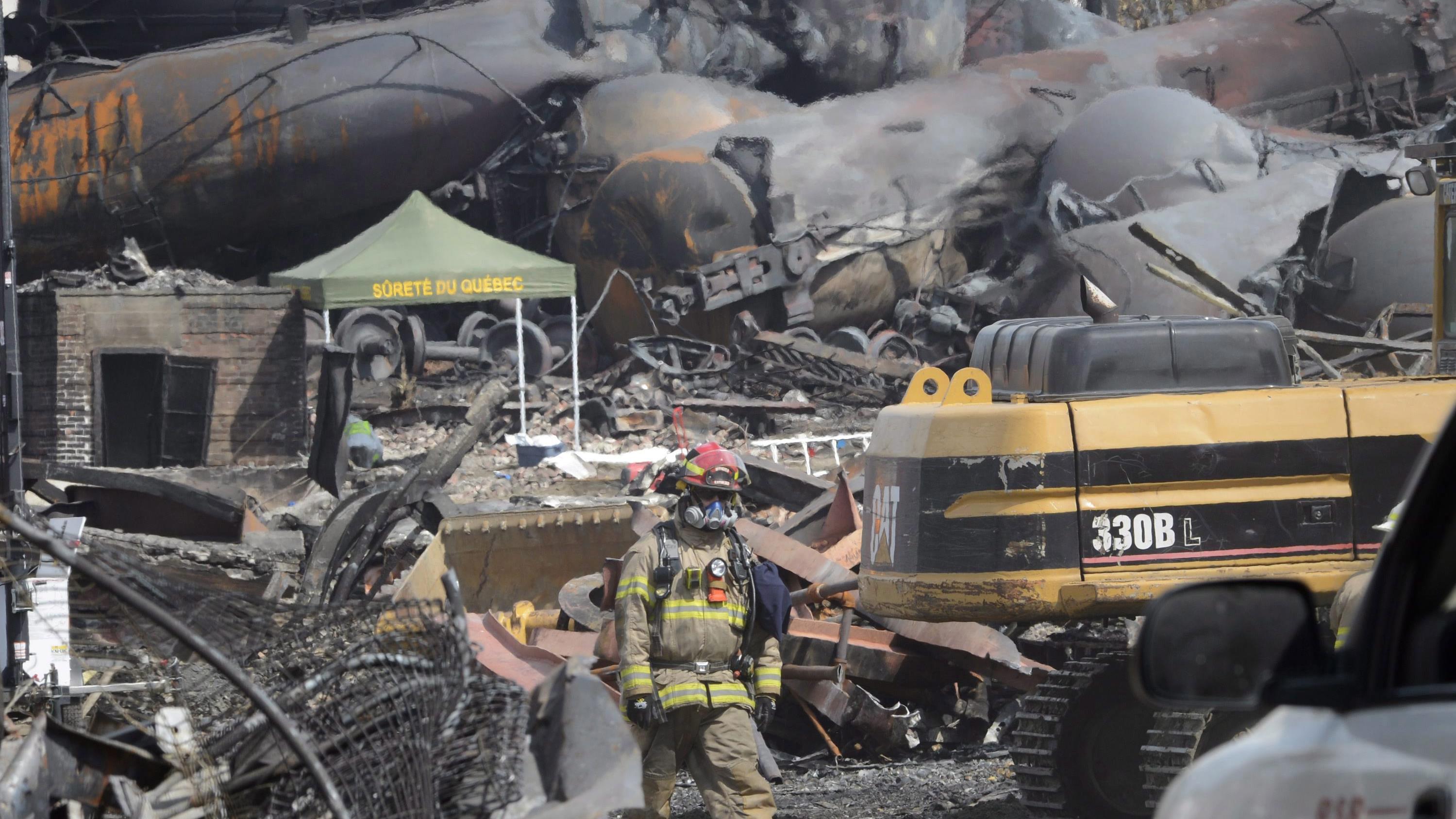 A firefighter inspects the damage left by the derailment and explosion of the runaway train in Lac-Megantic.