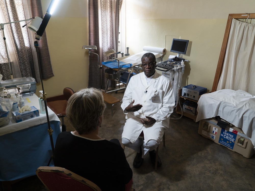 Assis, Denis Mukwege, et de dos, Sophie Langlois, entourés d’équipements médicaux.