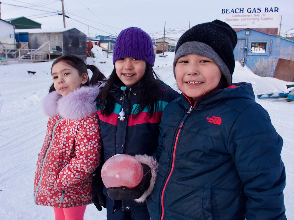 Trois jeunes filles s’amusent dehors après l’école à Iqaluit.