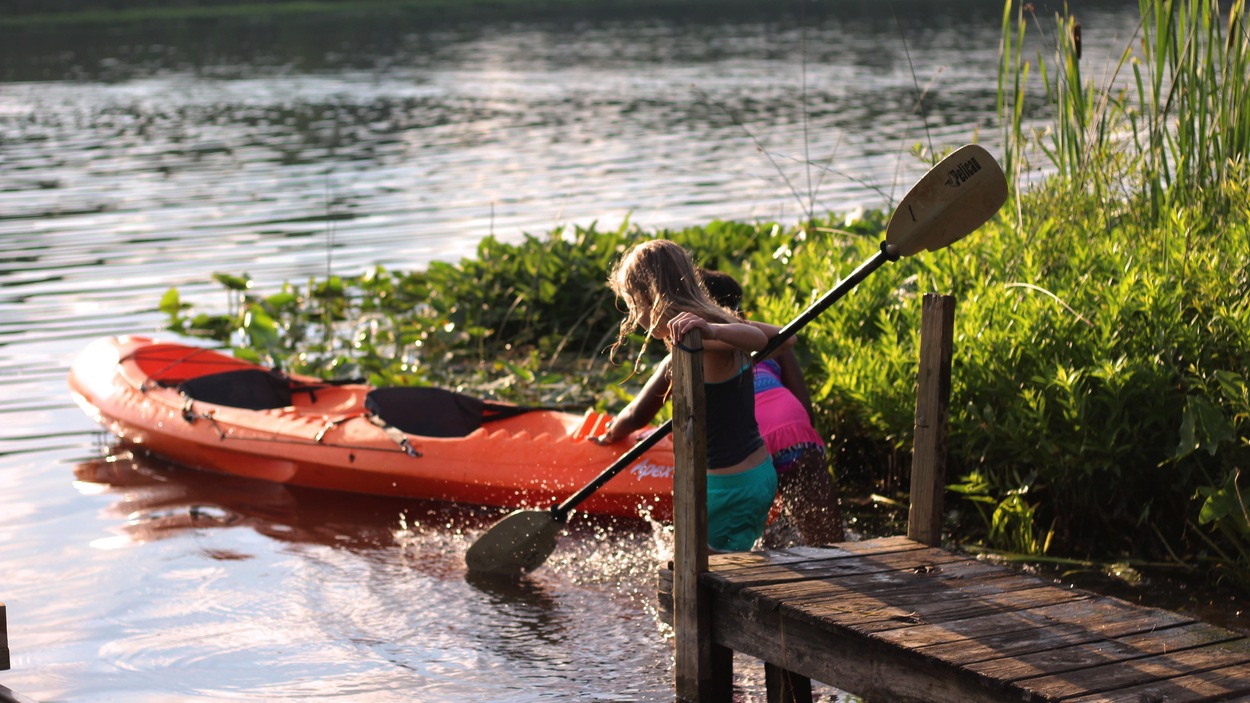 Deux fillettes tirent un kayak des eaux. Deux fillettes tirent un kayak des eaux.