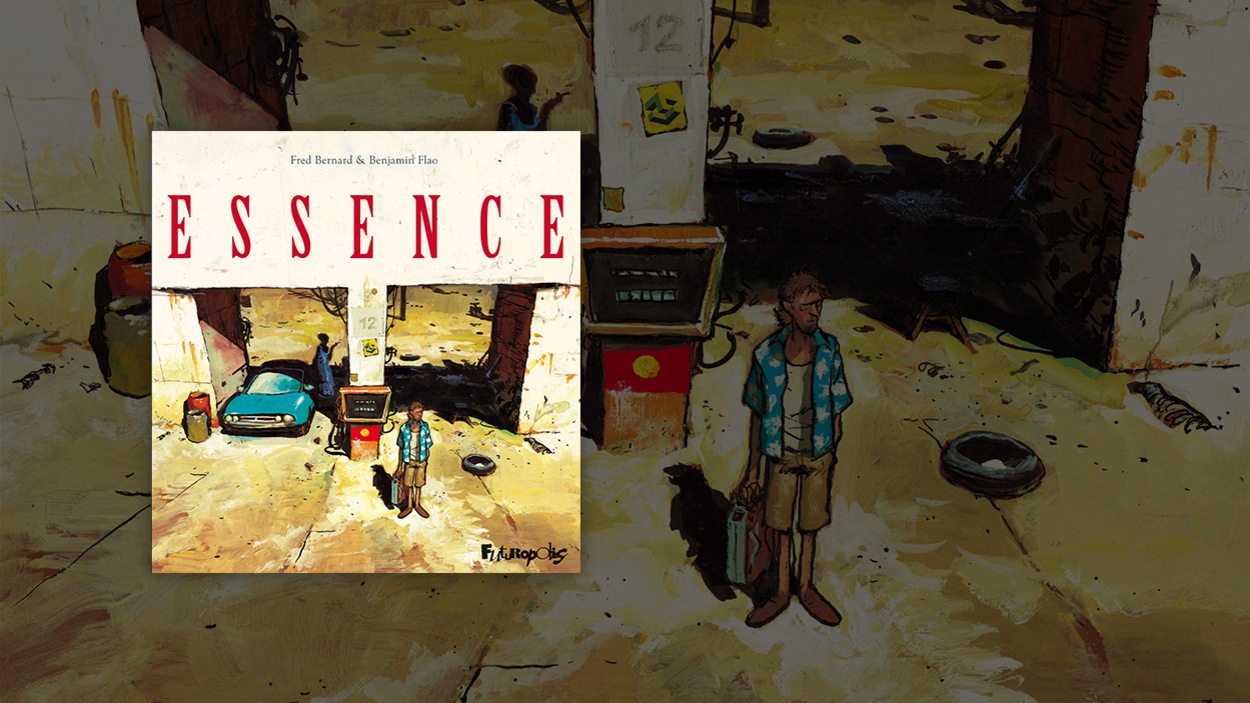 Un homme regarde au loin devant une station d'essence. Un homme regarde au loin devant une station d'essence.