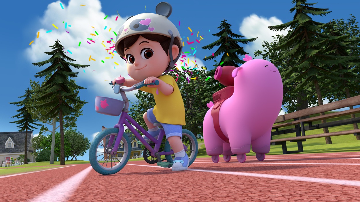 La fillette fait du vélo et son ami robot roule sur la piste