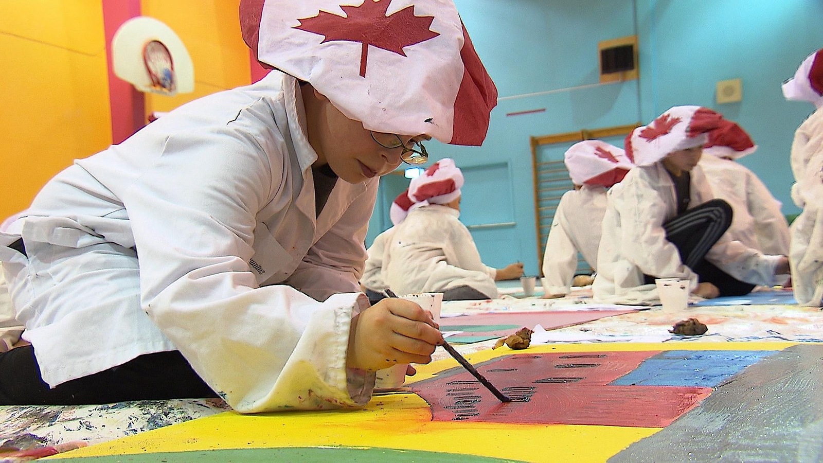 Un élève de l'école Marie-Immaculée peinture une partie de la murale. Un élève de l'école Marie-Immaculée peinture une partie de la murale.