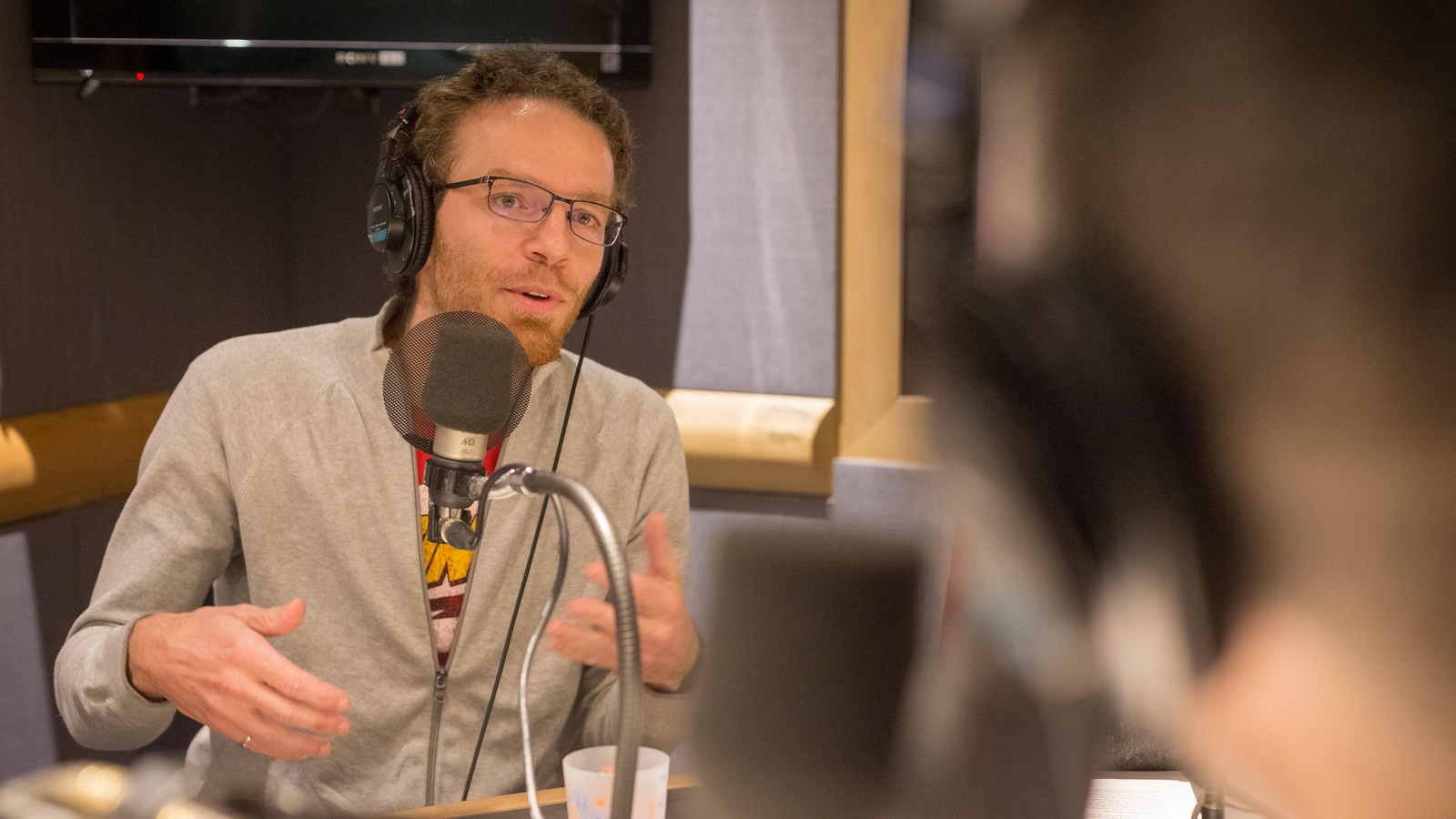 Une photo du professeur Nicolas Saunier en train de parler au micro dans un studio de radio. Une photo du professeur Nicolas Saunier en train de parler au micro dans un studio de radio.