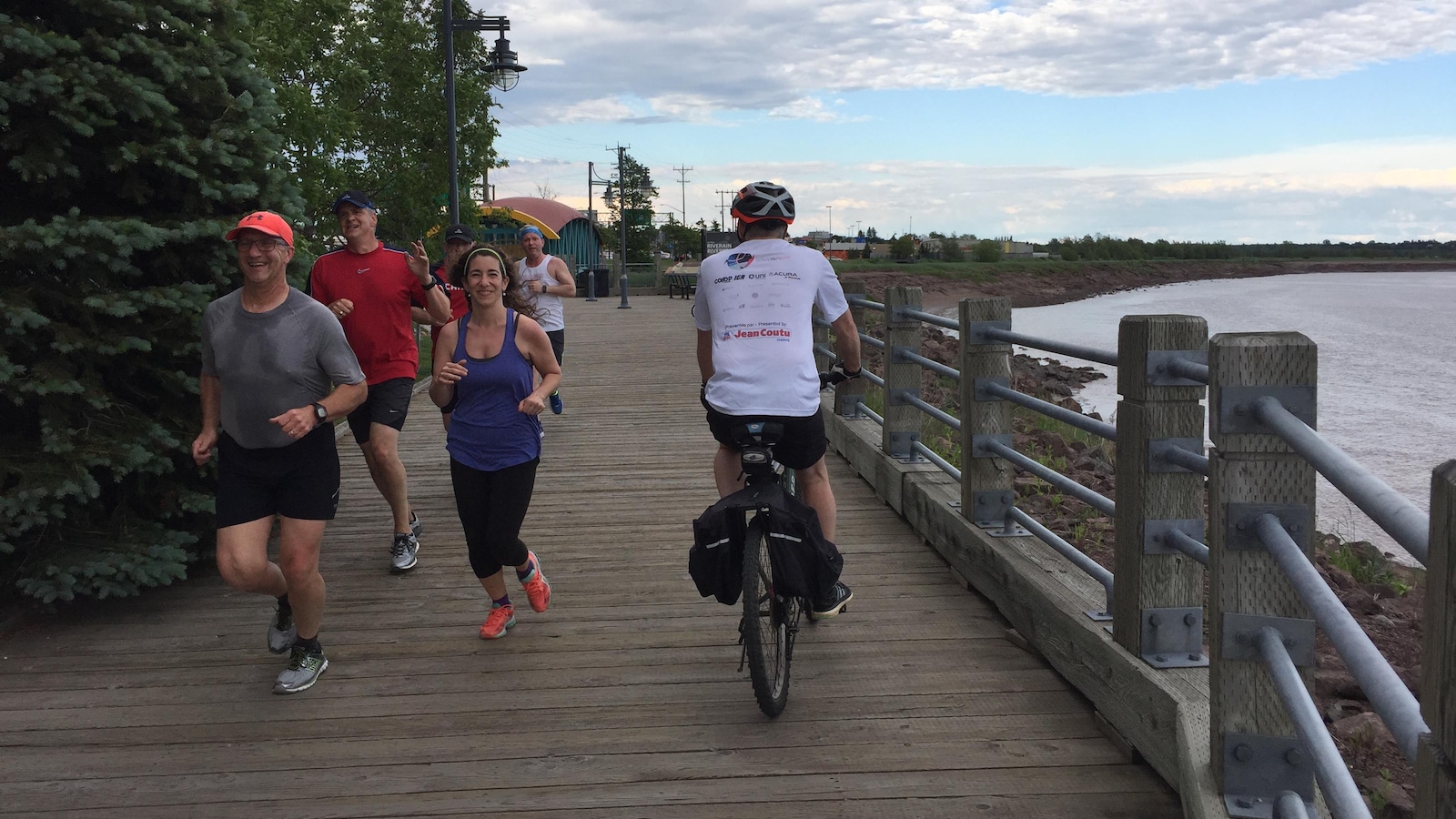 Des coureurs et un cycliste sur le sentier au bord de la rivière Petitcodiac Des coureurs et un cycliste sur le sentier au bord de la rivière Petitcodiac