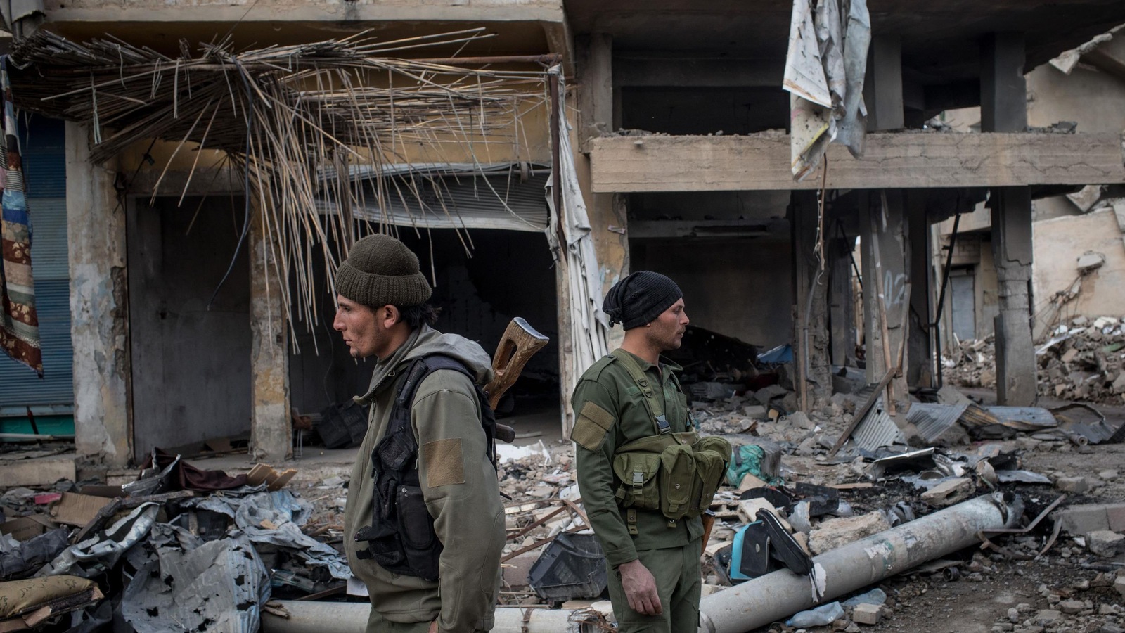 Deux hommes armés se tiennent debout, dos à dos, dans les décombres d'un bâtiment. Deux hommes armés se tiennent debout, dos à dos, dans les décombres d'un bâtiment.