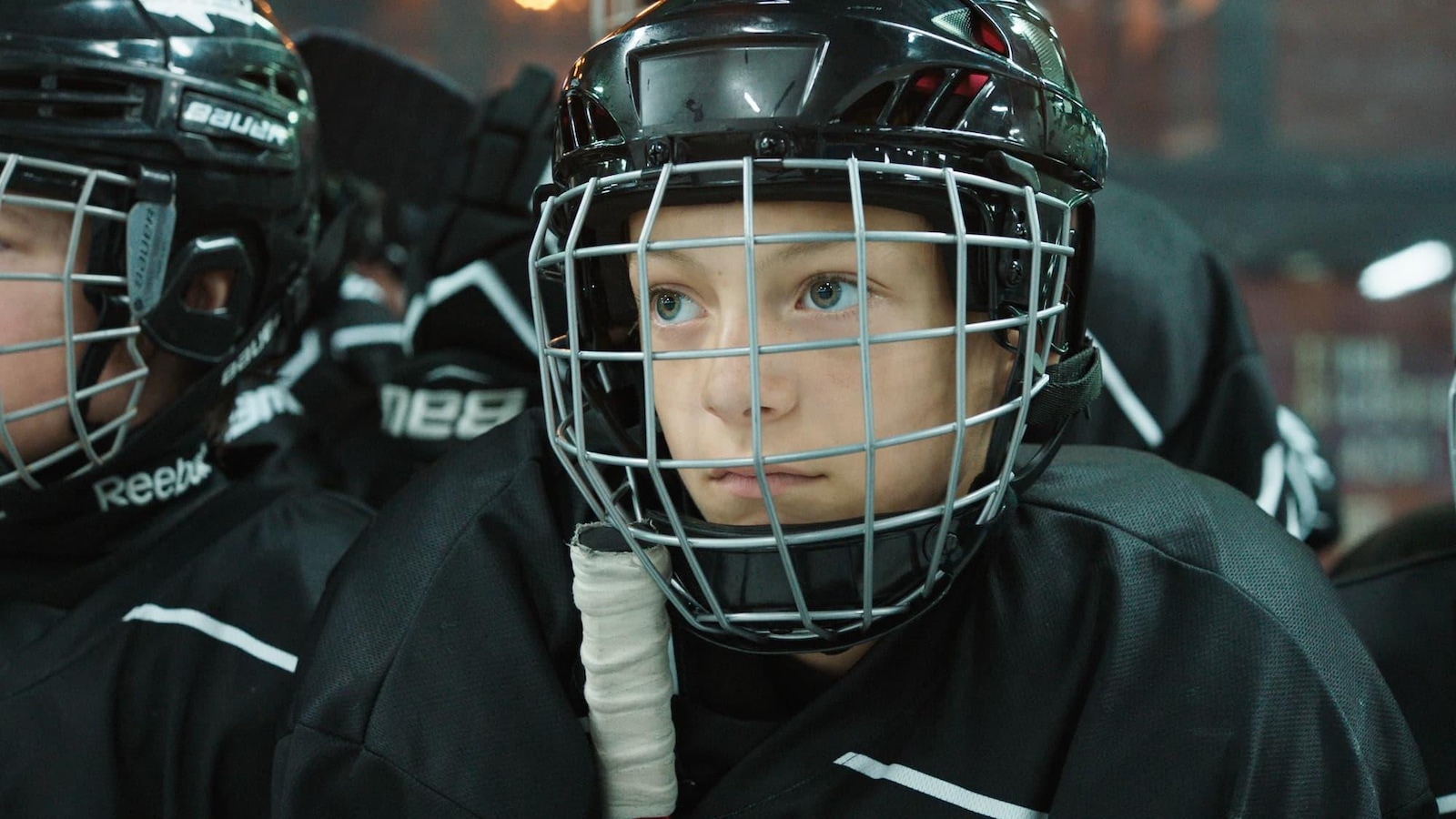 Un jeune garçon portant un masque et un uniforme de hockey. Un jeune garçon portant un masque et un uniforme de hockey.