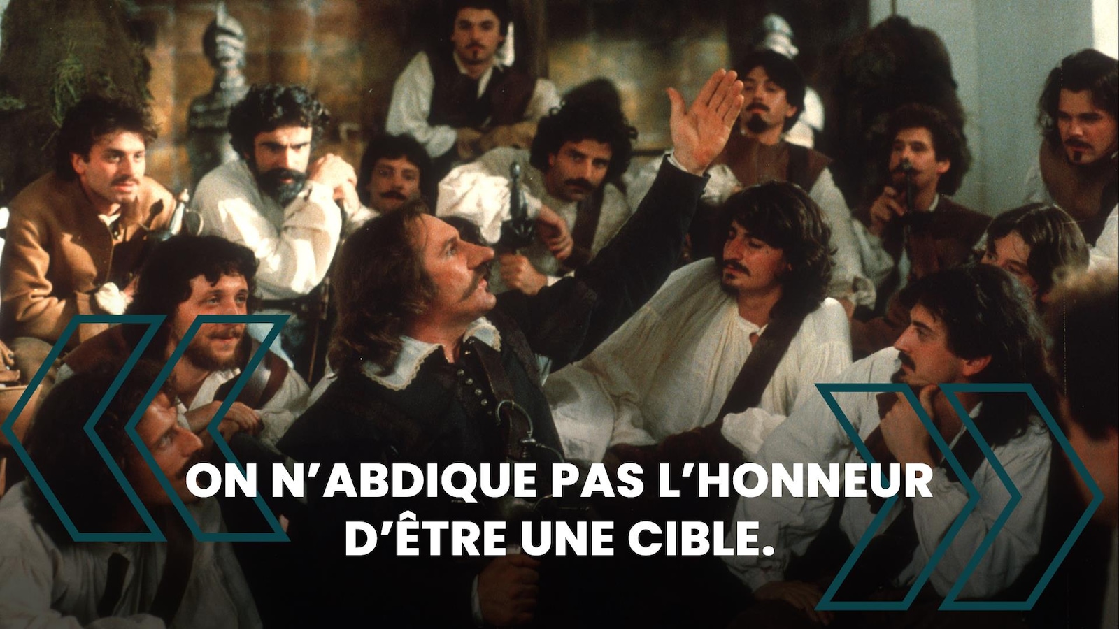 Un homme, la main en l'air, devant une troupe d'hommes qui l'écoute et la citation: On n'abdique pas l'honneur d'être une cible. Un homme, la main en l'air, devant une troupe d'hommes qui l'écoute et la citation: On n'abdique pas l'honneur d'être une cible.