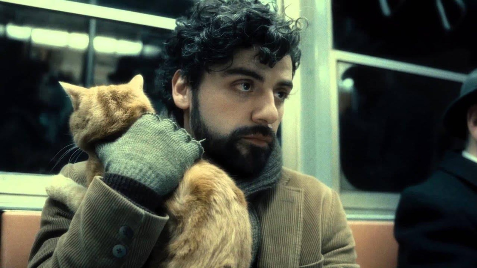 Un homme (Oscar Isaac) tient un chat dans ses bras, dans le métro. Un homme (Oscar Isaac) tient un chat dans ses bras, dans le métro.