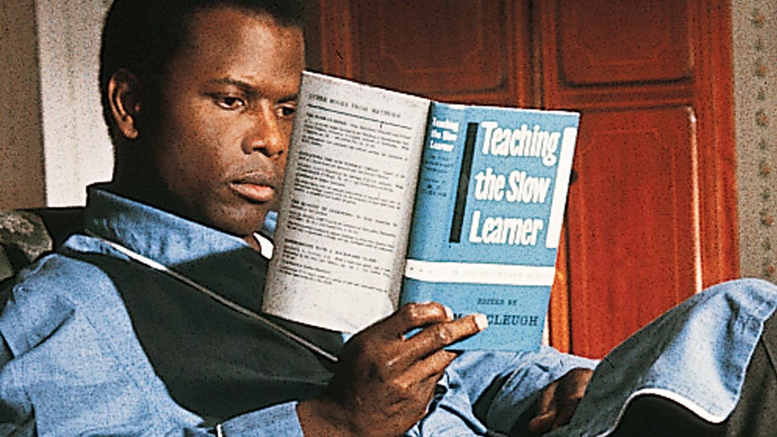 Un homme assis lit un livre. Un homme assis lit un livre.