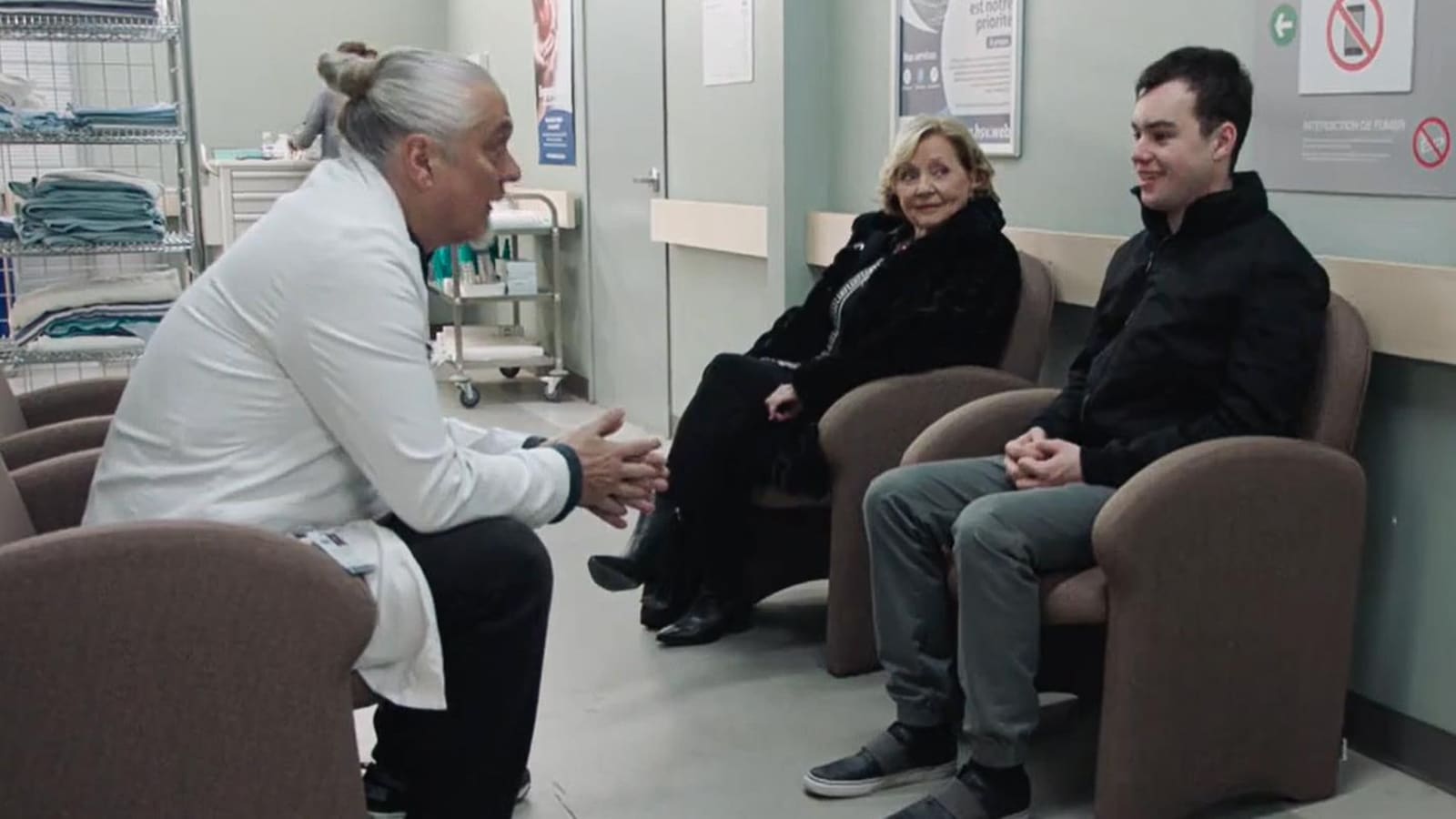 Pascal, Liliane et Siméon parlent dans un corridor de l'hôpital.