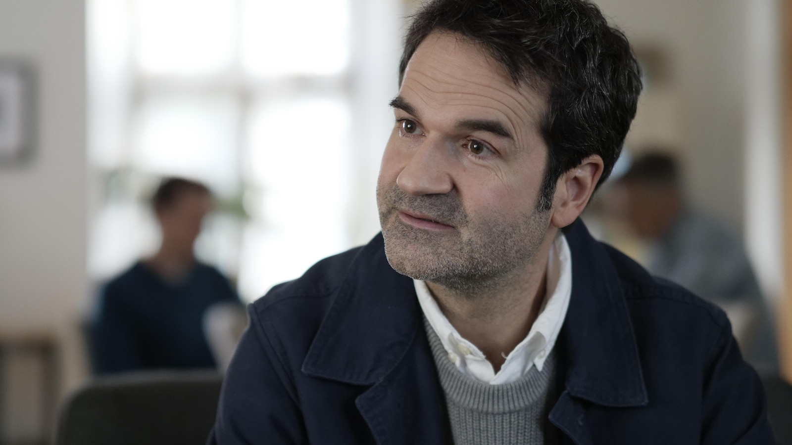 Assis dans le salon d'Anémone, le sergent-détective Duval (Michel Olivier Girard) pose des questions. Assis dans le salon d'Anémone, le sergent-détective Duval (Michel Olivier Girard) pose des questions.