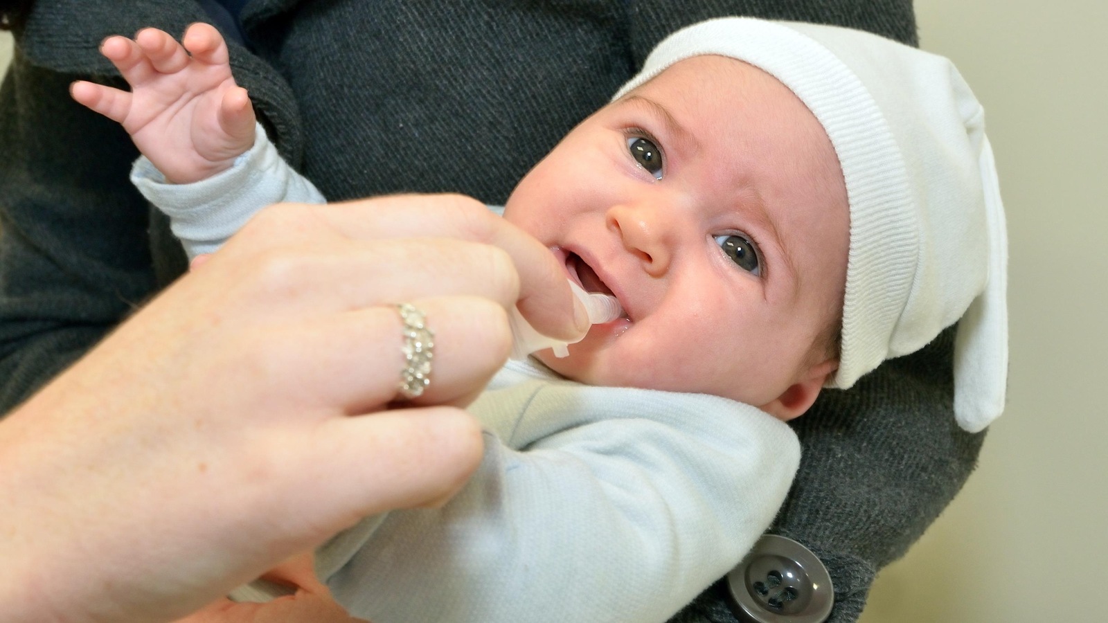 Une nourrisson reçoit un vaccin oral. Une nourrisson reçoit un vaccin oral.