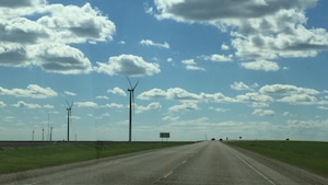 Des éoliennes vues d'une route dans le Manitoba rural.