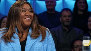 La femme est assise en studio.