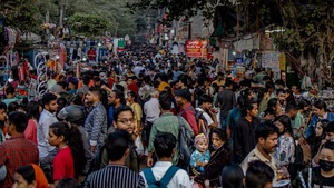 An alley where several public markets are located is crowded with people in India.