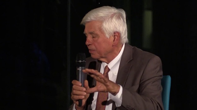 L'homme tient un micro lors d'une conférence. L'homme tient un micro lors d'une conférence.