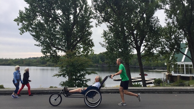 Marc Therrien pousse son père dans un Kartus, même si celui-ci n'a pas de problème de mobilité. Ils profitent de l'occasion pour faire une activité ensemble. Marc Therrien pousse son père dans un Kartus, même si celui-ci n'a pas de problème de mobilité. Ils profitent de l'occasion pour faire une activité ensemble.