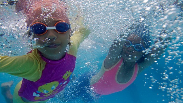 Des enfants qui se baignent, la tête sous l'eau.