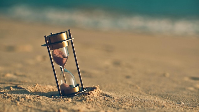 Un sablier dans le sable d'une plage
