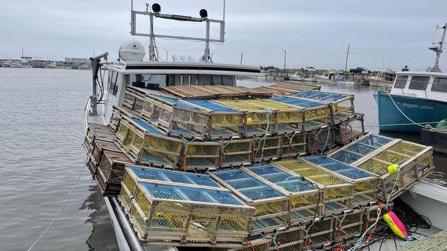 Un bateau rempli de casiers à homards dans le port de Baie Sainte-Anne.