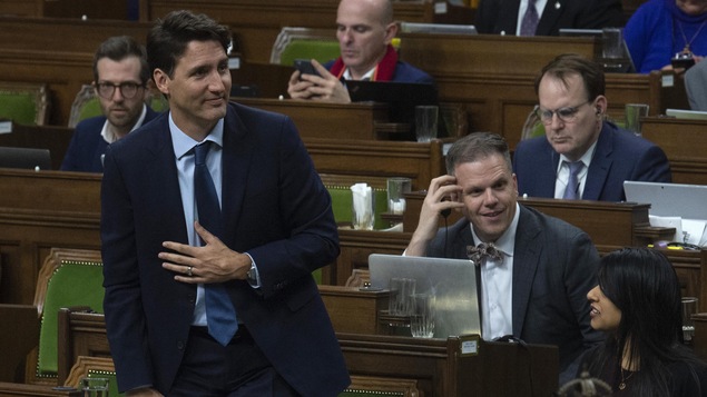 Prime Minister Justin Trudeau rises to vote during a marathon voting session in the House of Commons Thursday March 21, 2019 in Ottawa. The calendar indicates March 20th which is when the session of Parliament began voting. THE CANADIAN PRESS/Adrian Wyld