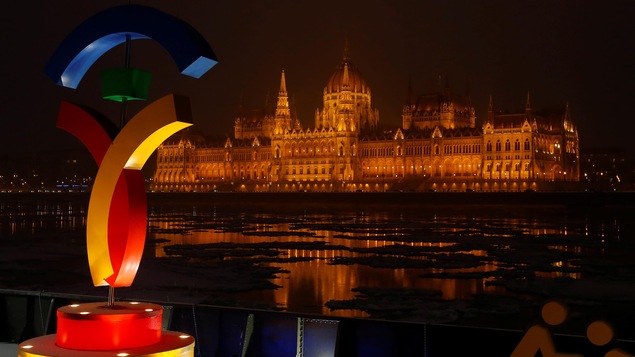 Le logo de la candidature olympique de Budapest avec, en arrière-plan, le parlement hongrois Le logo de la candidature olympique de Budapest avec, en arrière-plan, le parlement hongrois