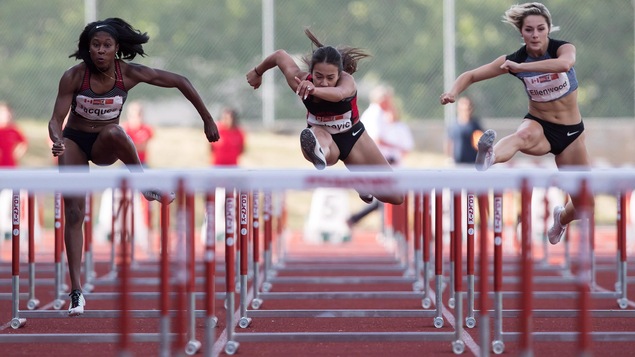 First-place finisher Farah Jacques, left, of Gatineau, Que., fourth-place finisher Katarina Vlahovic, of Surrey, B.C., and third-place finisher Georgia Ellenwood, right, of Langley, B.C., compete in the women's 100 metre hurdles during the Harry Jerome International Track Classic, in Burnaby, B.C., on Wednesday, June 27, 2018. THE CANADIAN PRESS/Darryl Dyck