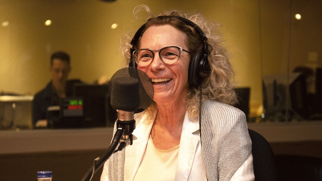 Danielle Trottier souriante derrière un micro.