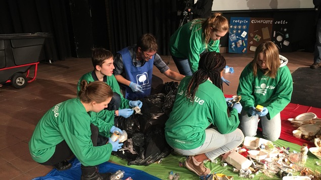 Des élèves avec ses gants de plastique, qui font le tri des sacs de poubelles