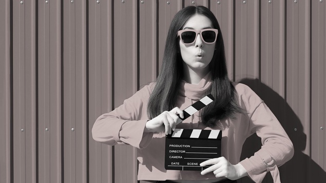 Une jeune femme tient une planche de production