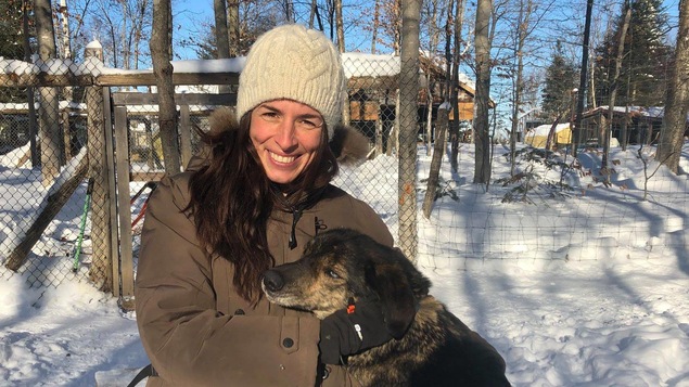Katherine Langlais pose avec un chien dans le chenil extérieur