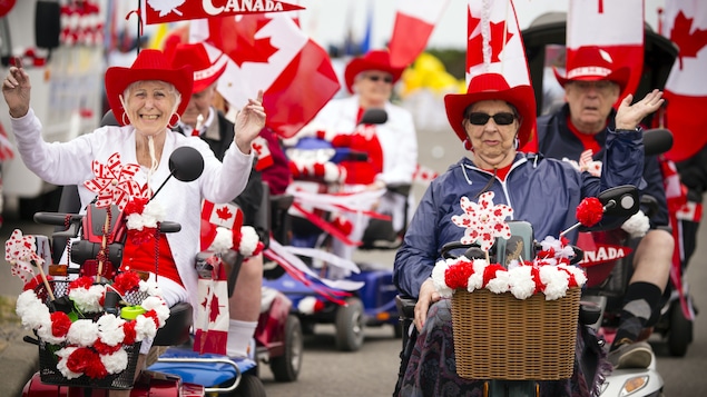 Deux personnes âgées marchent pour la fête du Canada.