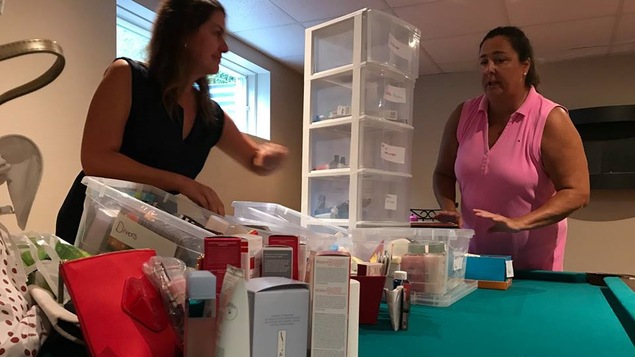 Deux femmes devant une table remplie de produits cosmétiques