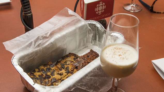 Un plat de gâteau aux fruits à côté d'un verre de lait de poule
