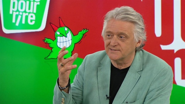 Gilbert Rozon devant le logo du Festival Juste pour rire.