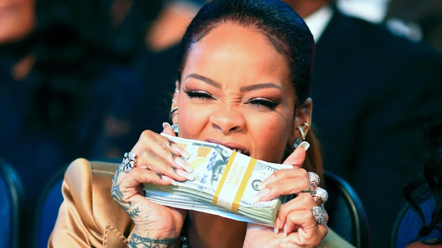 Rihanna aux BET Awards, le 28 juin 2015, avec une pile de billets de banque entre les dents.