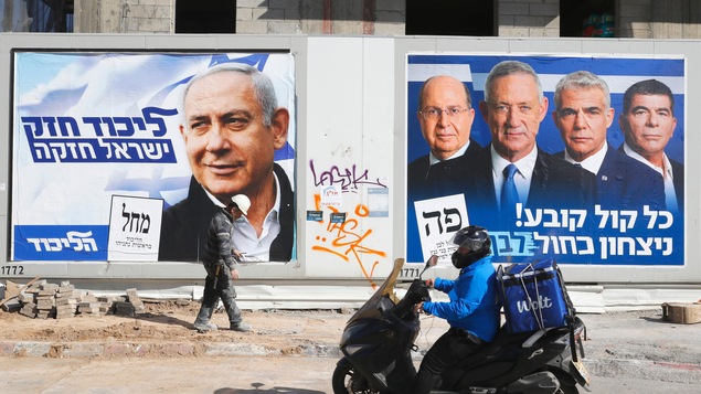 La photo est prise de jour et les deux affiches montrent le visage des candidats. Nétanyahou est seul, tandis que Gantz est entouré de trois autres candidats.