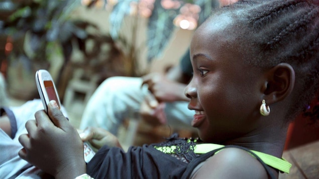 Une jeune fille avec un téléphone cellulaire