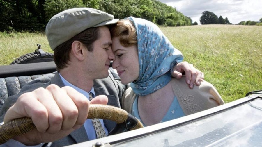 Au volant d'une voiture décapotable, un homme (Andrew Garfield) enlace une femme (Claire Foy) à ses côtés.