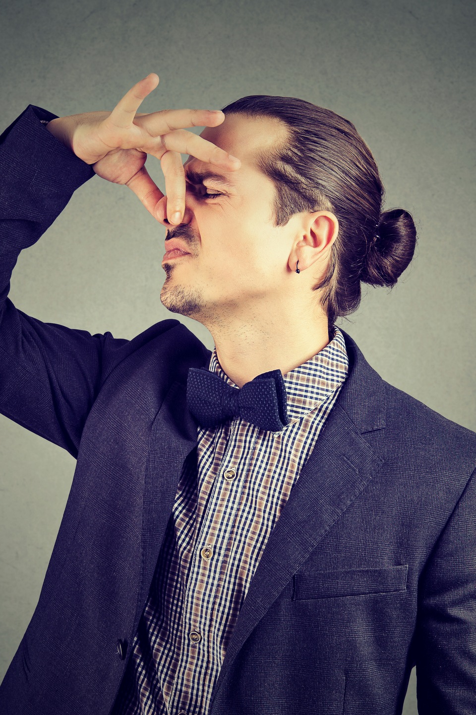 Un homme se pince le nez. Un homme se pince le nez.